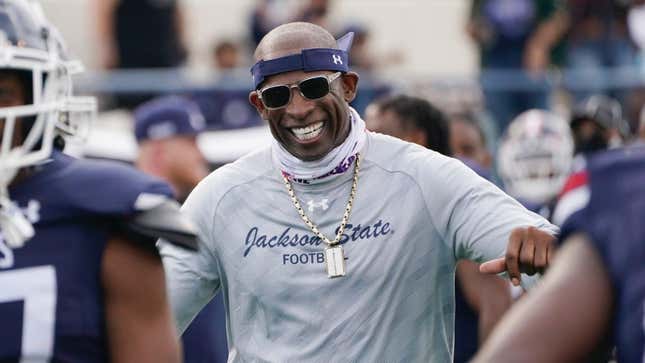 Jackson State football coach Deion Sanders greets his defensive squad after they recovered a Mississippi Valley State fumble for a touchdown in March, 2021.