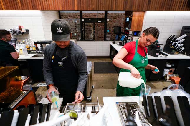 Tryer Lab partners Chan Chan and Emma Parnello, right, make drinks while running a reusable cup test at the Tryer Center at Starbucks headquarters, Wednesday, June 28, 2023, in Seattle. Part of the company&#39;s goals is to cut waste, water use and carbon emissions in half by 2030. (AP Photo/Lindsey Wasson)