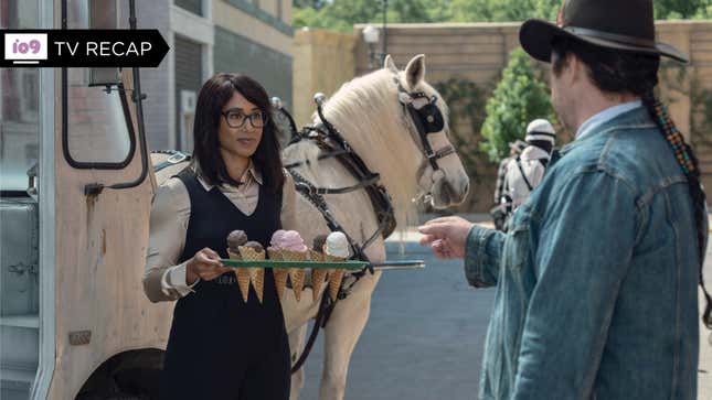Eugene (Josh McDermitt) points at Max's (Margot Bingham) ice cream cones as she stands in front of a horse-drawn ice cream truck in The Walking Dead.