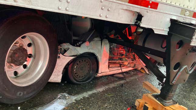 Car under semi-truck 