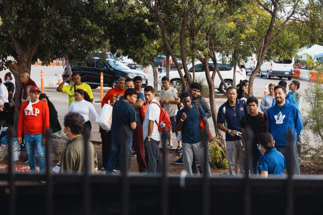 Groups of migrants sit outside the Migrant Resource Center on September 19, 2022 in San Antonio, Texas. The City of San Antonio Migrant Resource Center is the place of origin of the two planeloads of mostly Venezuelan migrants who were sent via Florida to Martha’s Vineyard in Massachusetts by Florida Gov. Ron DeSantis.
