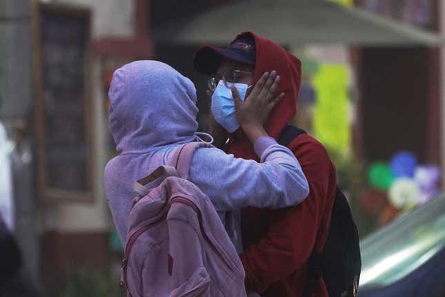 A couple wear hoodies and masks to protect themselves from the ash fall of the Popocatépetl volcano in Atlixco, Mexico, on May 22, 2023.