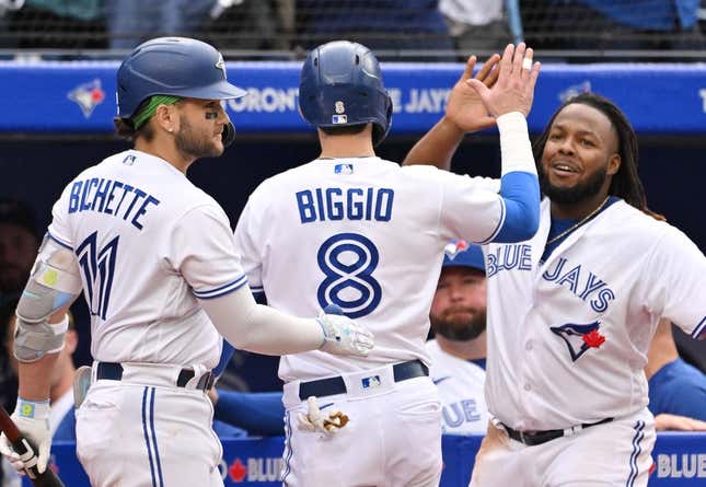Sep 16, 2023; Toronto, Ontario, CAN; Toronto Blue Jays pinch runner Cavan Biggio (8) celebrates with shortstop Bo Bichette (11) and first baseman Vladimir Guerrero Jr. (27) after scoring against the Boston Red Sox in the ninth inning at Rogers Centre.