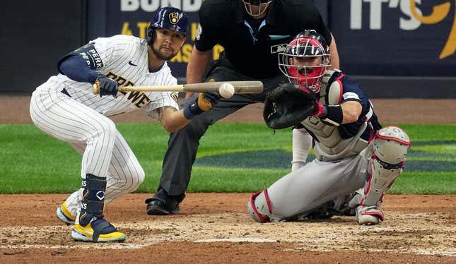 Apr 23, 2023; Milwaukee, Wisconsin, USA; Milwaukee Brewers center fielder Blake Perkins (16) bunts during the seventh inning of their game against the Boston Red Sox at American Family Field.