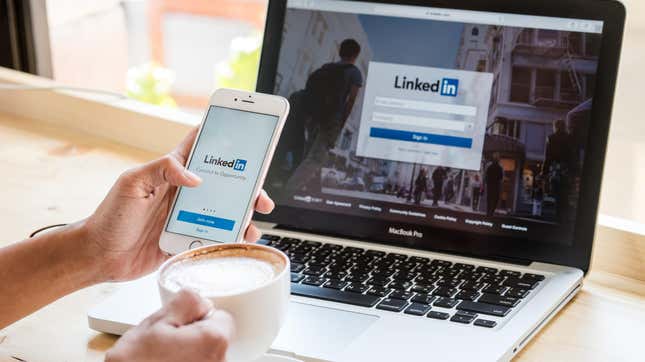 Stock photo of LinkedIn login page on phone and computer
