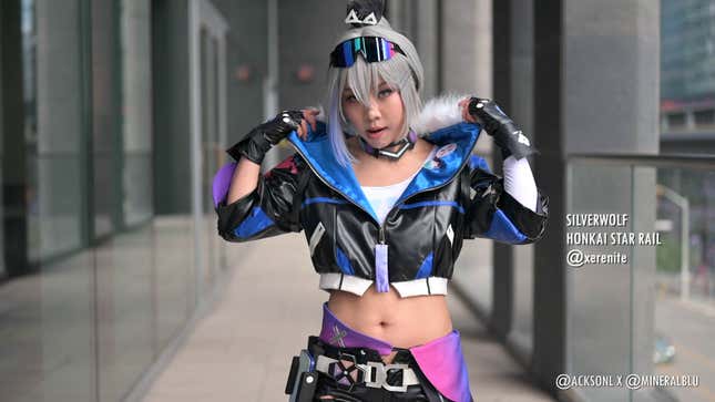 A cosplayer dressed as Silverwolf from Honkai Star Rail pops their collar. 