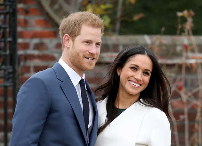 Prince Harry and Meghan pictured smiling. 