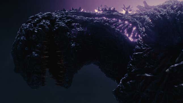 A melancholy Godzilla stares thoughtfully at the ground.