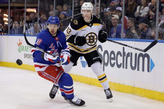 Jan 19, 2023; New York, New York, USA; Boston Bruins center Charlie Coyle (13) plays the puck ahead against New York Rangers left wing Artemi Panarin (10) during the second period at Madison Square Garden.