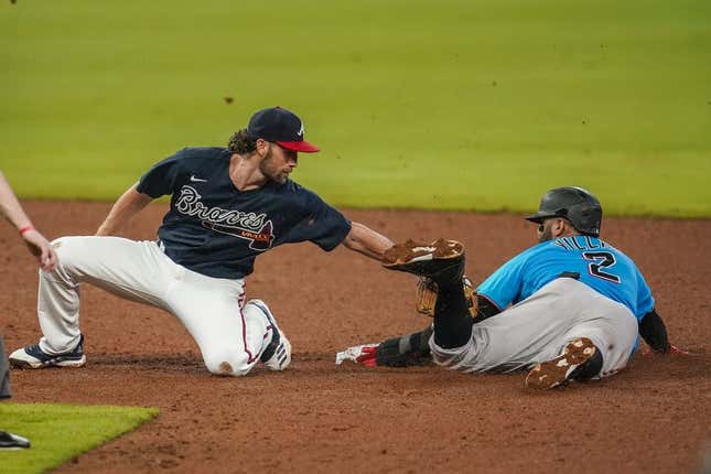 July 21, 2020;  Cumberland, Georgia, USA;  Miami Marlins second baseman Jonathan Villar (2) steals second base behind Atlanta Braves shortstop Charlie Culberson (8) during the sixth inning at Truist Park.