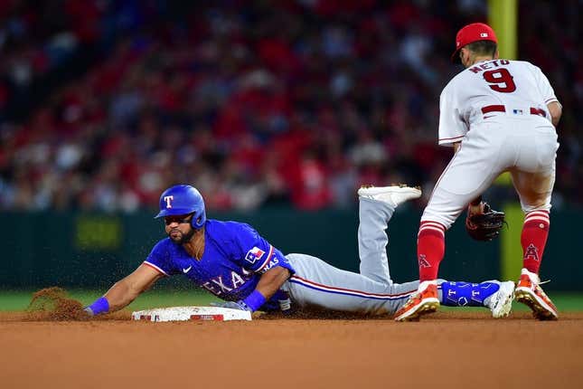 May 5, 2023; Anaheim, California, USA; Texas Rangers center fielder Leody Taveras (3) reaches second on a double ahead of Los Angeles Angels shortstop Zach Neto (9) during the fifth inning at Angel Stadium.