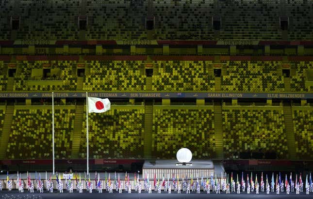 Aug 24, 2021; Tokyo, Japan; Athlete&#39;s Parade Assistants holding flags of the competing countries in front of the Protocol Stage during the Athlete&#39;s Parade at the Opening Ceremony of the Tokyo 2020 Paralympic Games.