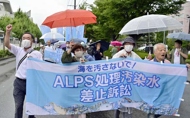 A group of plaintiffs and supporters, demanding revokation of TEPCO&#39;s treated water discharge plan, head to the Fukushima District Court to file a lawsuit, in Fukushima, northeastern Japan, Friday, Sept. 8, 2023. Fishermen and residents of Fukushima and five other prefectures along Japan’s northeastern coast filed a lawsuit Friday demanding a halt to the ongoing release of treated radioactive wastewater from the wrecked Fukushima nuclear plant into the sea. The banner reads &quot;Lawsuit to halt the release of ALPS treated radioactive wastewater.&quot;(Kyodo News via AP)