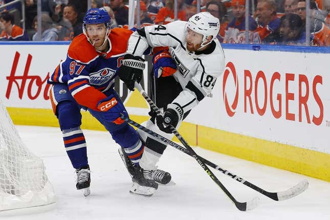 Apr 25, 2023; Edmonton, Alberta, CAN;Edmonton Oilers forward Connor McDavid (97) and Los Angeles Kings defensemen Vladislav Gavrikov (84) battle for a loose puck during the third period in game five of the first round of the 2023 Stanley Cup Playoffs at Rogers Place.