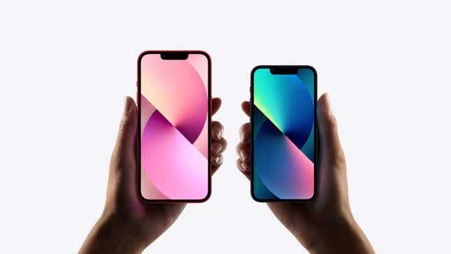 Two hands holding Apple iPhones of differing sizes