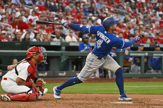 Mar 30, 2023; St. Louis, Missouri, USA; Toronto Blue Jays right fielder George Springer (4) hits a single against the St. Louis Cardinals during the ninth inning at Busch Stadium.