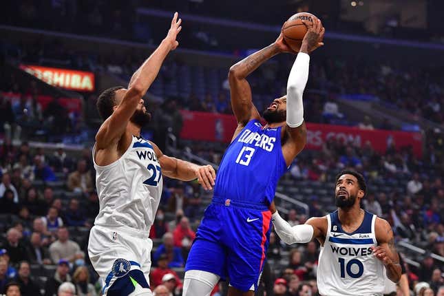 Feb 28, 2023; Los Angeles, California, USA; Los Angeles Clippers forward Paul George (13) shoots against Minnesota Timberwolves center Rudy Gobert (27) and guard Mike Conley (10) during the first half at Crypto.com Arena.