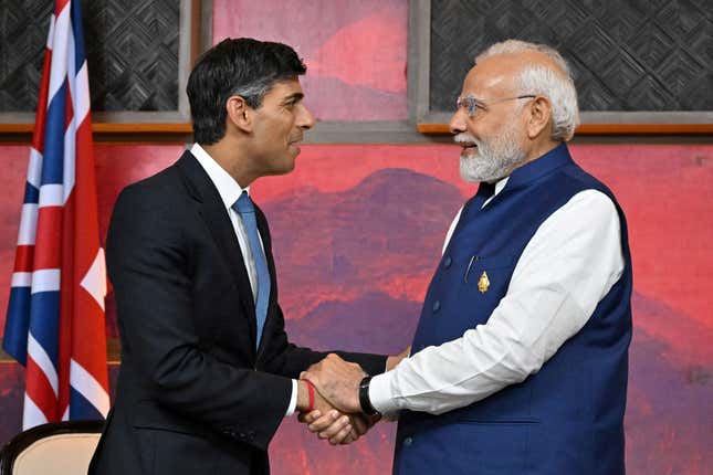 UK prime minister Rishi Sunak and Indian prime minister Narendra Modi clasp hands while meeting at the G20 summit