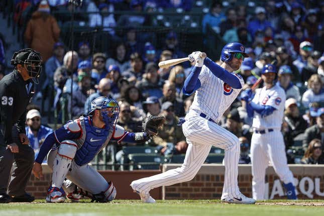 Apr 7, 2023; Chicago, Illinois, USA; Chicago Cubs center fielder Cody Bellinger (24) hits an RBI-single against the Texas Rangers during the fourth inning at Wrigley Field.