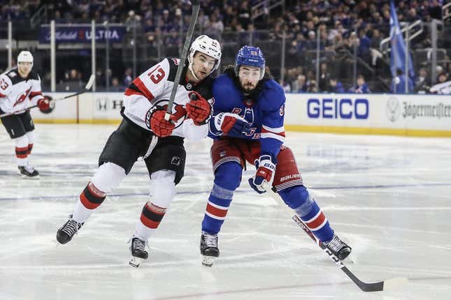 Apr 22, 2023; New York, New York, USA; New Jersey Devils center Nico Hischier (13) and New York Rangers center Mika Zibanejad (93) battle for control of the puck in game three of the first round of the 2023 Stanley Cup Playoffs at Madison Square Garden.