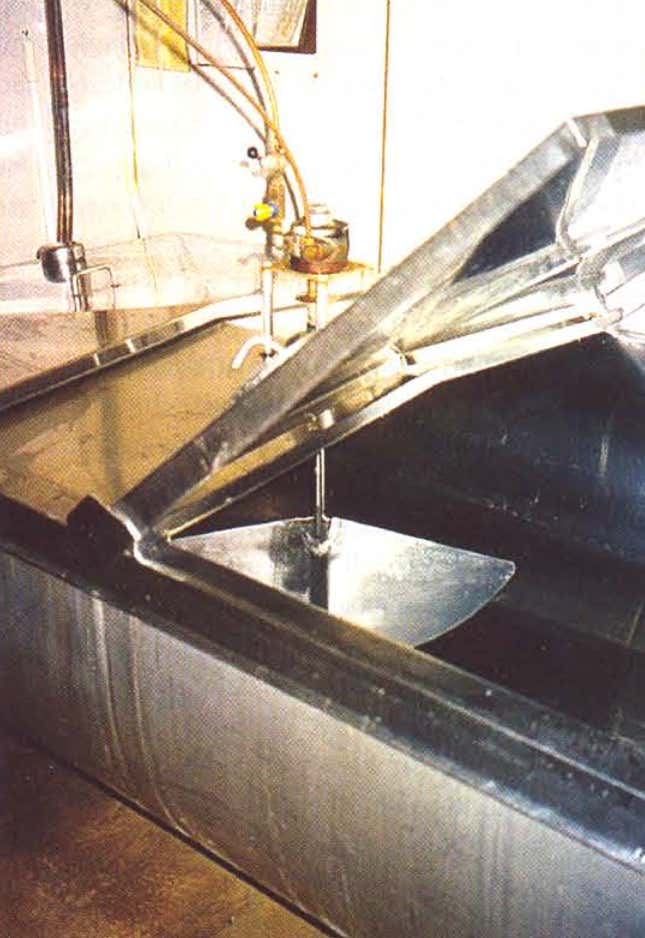 A tank and propane-powered milk agitator on an Amish farm.