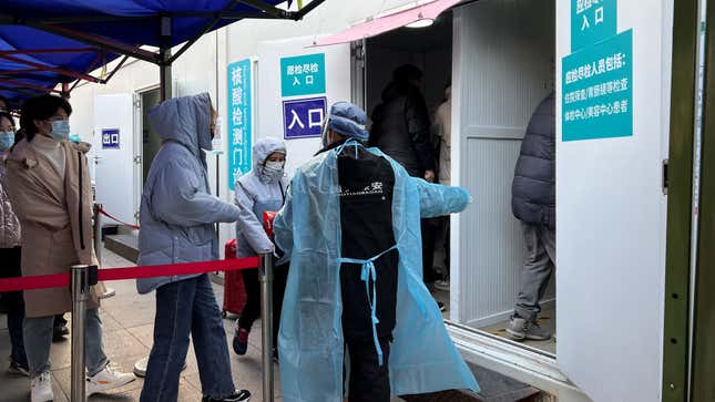 A security guard guides people to take covid tests in Beijing.