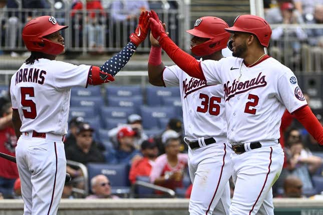 Apr 29, 2023; Washington, District of Columbia, USA; Washington Nationals second baseman Luis Garcia (2) and left fielder Stone Garrett (36) are congratulated by shortstop CJ Abrams (5) after scoring against the Pittsburgh Pirates during the fourth inning at Nationals Park.
