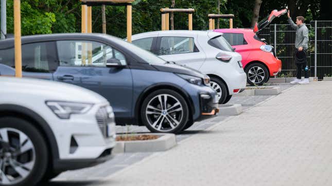 A row of four electric cars charging in Europe. 