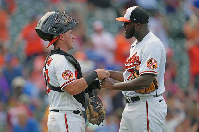Jul 19, 2023; Baltimore, Maryland, USA; Baltimore Orioles pitcher Felix Bautista (right) greets catcher James McCann (left) after earning a save against the Los Angeles Dodgers at Oriole Park at Camden Yards.