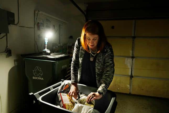 Leah Thomas looks over her disposed food items, Monday, Feb. 27, 2023, in Beverly Hills in Oakland County, Michigan. 