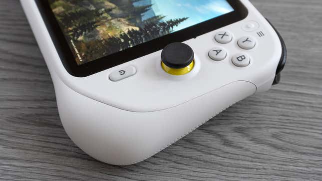 A close up of the action buttons and right joystick on the Logitech G Cloud against a gray wooden background.
