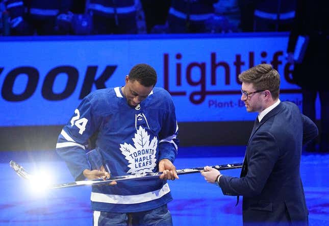 Mar 8, 2022; Toronto, Ontario, CAN; Toronto Maple Leafs general manager Kyle Dubas (right) presents forward Wayne Simmonds (24) with a silver stick after having played in his 1,000th game before a game against the Seattle Kraken at Scotiabank Arena.