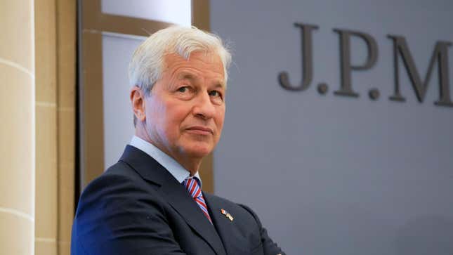 Jamie Dimon stands in front of a door with a JPMorgan sign on it