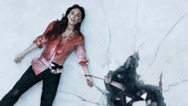 Megan Fox's Emma lays on broken ice, covered in blood, and handcuffed to her dead husband who has already fallen through the ice in the horror film Till Death.
