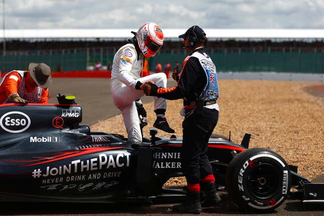 Jenson Button of Great Britain and McLaren Honda climbs out of his car after retiring in the 2015 British Grand Prix.