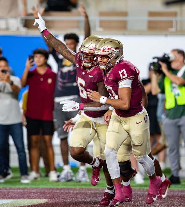 Florida State Seminoles tight end Jaheim Bell (6) and Florida State Seminoles quarterback Jordan Travis (13) celebrate a touchdown during a game against the LSU Tigers on Sunday, Sept. 3, 2023.
