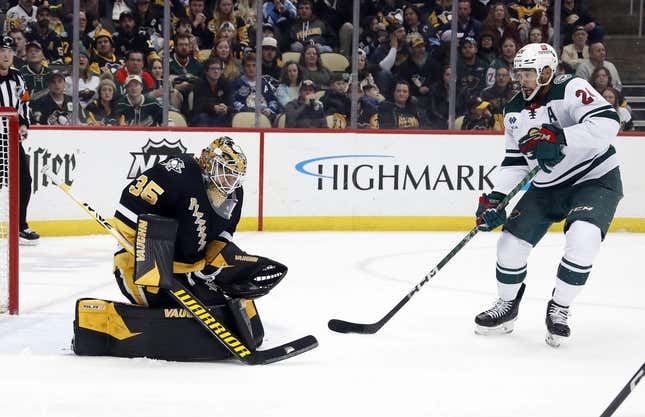 Apr 6, 2023; Pittsburgh, Pennsylvania, USA; Pittsburgh Penguins goaltender Tristan Jarry (35) makes a save in front of Minnesota Wild defenseman Matt Dumba (24) during the first period at PPG Paints Arena.