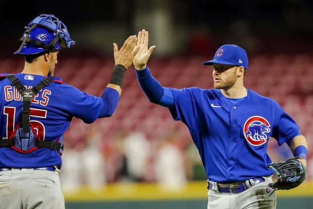 Apr 4, 2023; Cincinnati, Ohio, USA; Chicago Cubs left fielder Ian Happ (8) high fives catcher Yan Gomes (15) after the victory over the Cincinnati Reds at Great American Ball Park.
