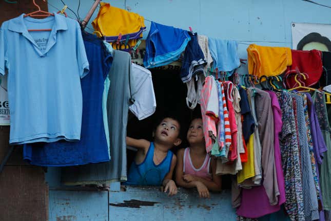 Filipino children look out from a window during an anti-drug operation at an informal settlers community in Pasig city, east of Manila, Philippines, in November 2016.
