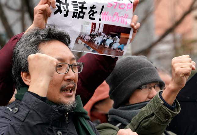Protesters shout slogans outside the venue of an evacuation drill simulating a North Korea ballistic missile attack in Tokyo.