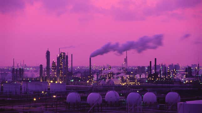 The sun sets over an Exxon oil refinery.