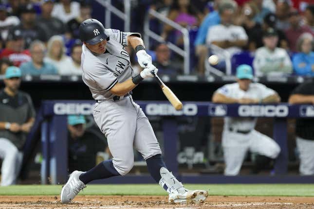 Aug 11, 2023; Miami, Florida, USA; New York Yankees shortstop Anthony Volpe (11) hits a three-run home run against the Miami Marlins during the second inning at loanDepot Park.