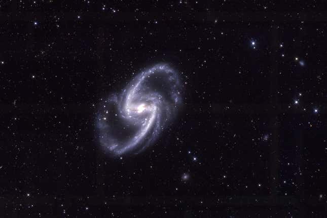 NGC 1365 is a pale spiral galaxy.