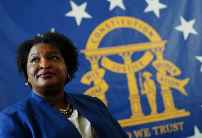 Democratic candidate for Georgia Governor Stacey Abrams poses for a portrait in front of the State Seal of Georgia Monday, Aug. 8, 2022, in Decatur, Ga.