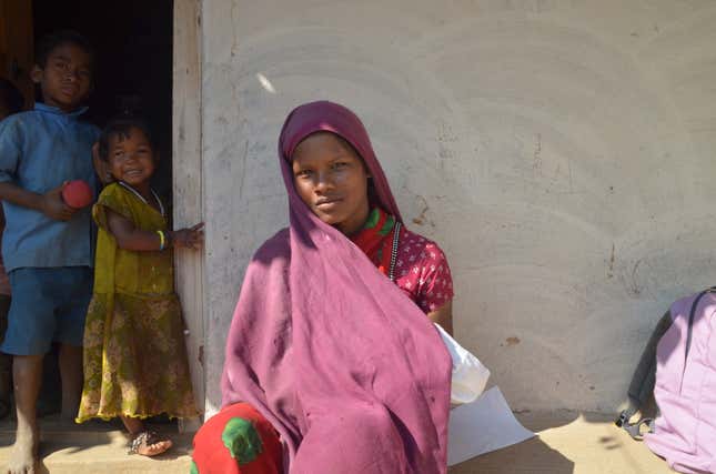 Rani nurses her infant as she waits for a protein feed distributed by the government through a nutrition programme in Surguja district.