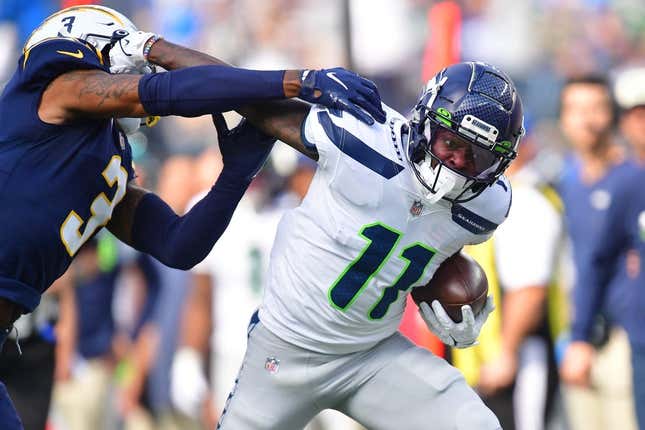 Oct 23, 2022; Inglewood, California, USA; Seattle Seahawks wide receiver Marquise Goodwin (11) runs the ball against Los Angeles Chargers safety Derwin James Jr. (3) during the first half at SoFi Stadium.