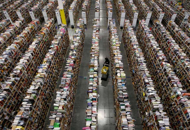 A warehouse showing many, many stacks of books.