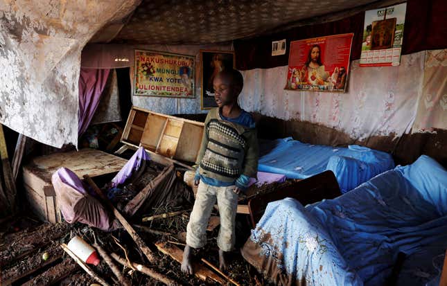 A child walks in his house, which was partly destroyed by flooding water after a dam burst, in Solio town near Nakuru, Kenya May 10, 2018.