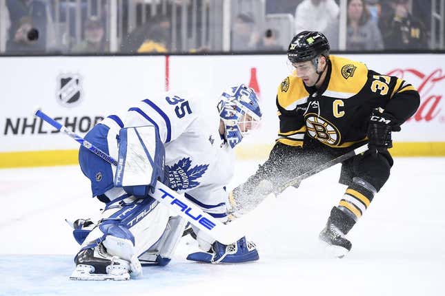 Apr 6, 2023; Boston, Massachusetts, USA;  Toronto Maple Leafs goaltender Ilya Samsonov (35) holds up the puck in front of Boston Bruins center Patrice Bergeron (37) during the first period at TD Garden.