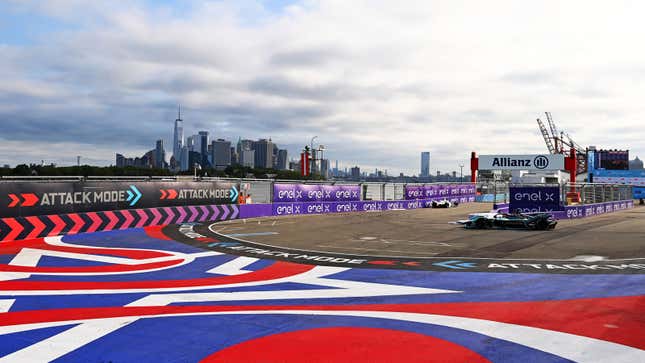 Formula E cars race against the backdrop of the New York Skyline